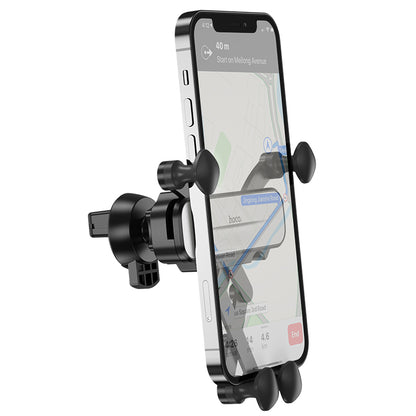 Hoco CA102 retractable gravity car phone holder mounted on vehicle air vent with phone secured in place.
