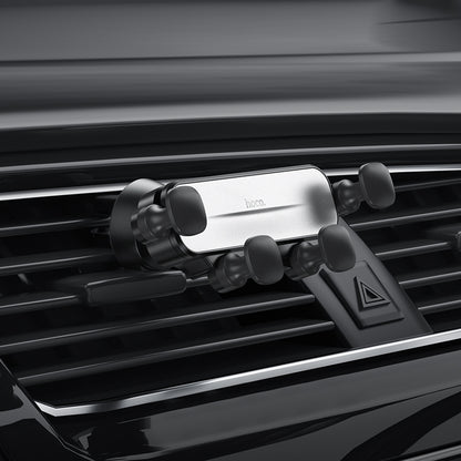 Hoco CA102 retractable gravity air vent car phone holder attached to vehicle air vent with phone secured in place.