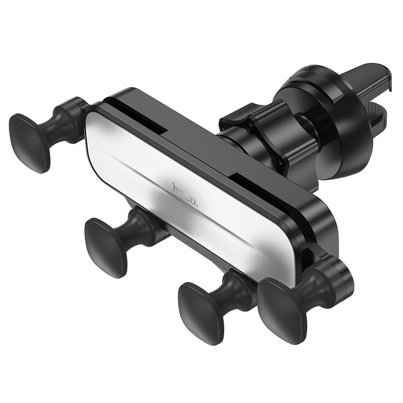 Hoco CA102 retractable gravity car phone holder mounted on dashboard, holding a smartphone securely with automatic grip mechanism.