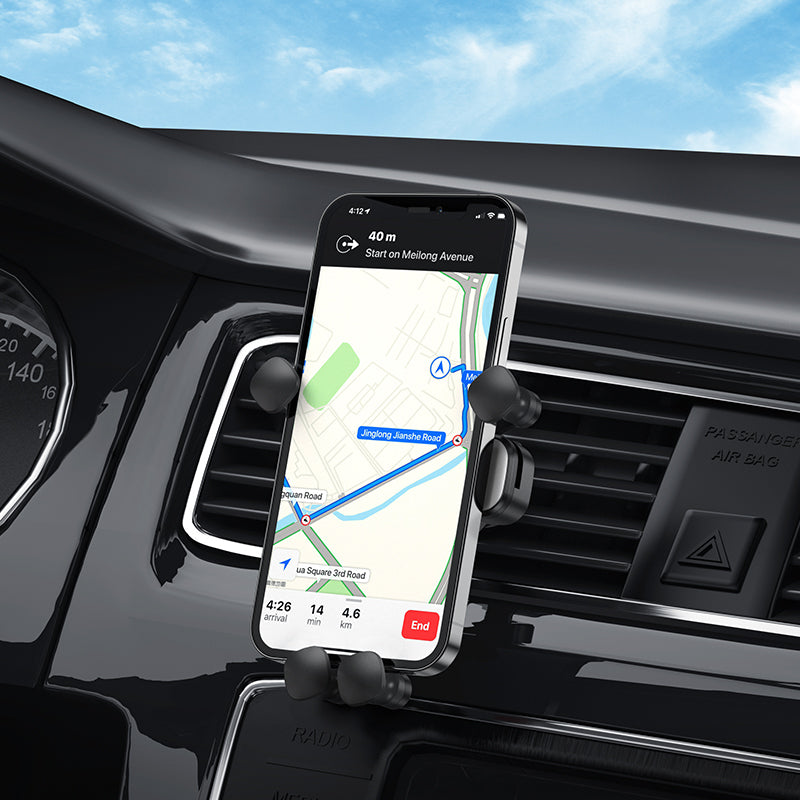 Hoco CA102 retractable gravity car phone holder attached to vehicle air vent, holding a smartphone securely.