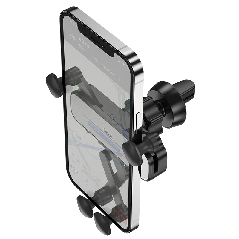 Hoco CA102 retractable gravity car phone holder attached to vehicle air vent with smartphone secured in place.
